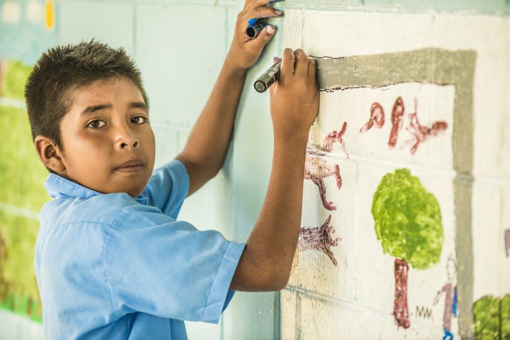 Ervin painting Earth Day Murals. Photo: Sergio Izquierdo
