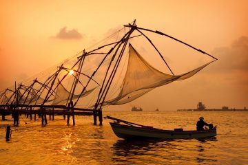 Sunset over Chinese fishing nets and boat in cochin kochi , kerala, india